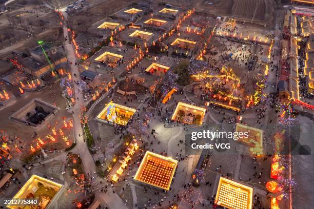 Aerial view of tourists visiting underground cave dwelling with festive decorations during the Spring Festival holiday on February 13, 2024 in...