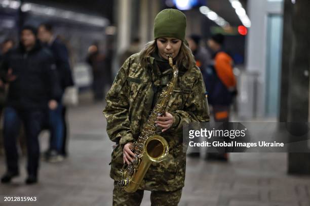 Ukrainian servicewoman plays saxophone before a concert of ‘Zhadan i Sobaky’ band for the Ukrainian military and their loved ones at the Kyiv train...