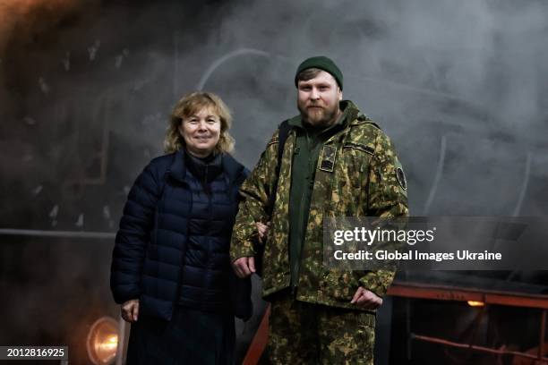 Ukrainian soldier and a woman stand in front of a train before a concert of ‘Zhadan i Sobaky’ band for the Ukrainian military and their loved ones at...