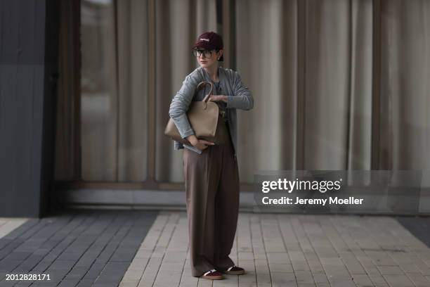 Maria Barteczko seen wearing Victoria Beckham black oversized aviator glasses, silver earrings, New Balance burgundy red logo baseball cap, HANRO...