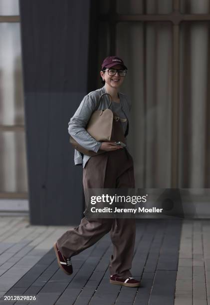 Maria Barteczko seen wearing Victoria Beckham black oversized aviator glasses, silver earrings, New Balance burgundy red logo baseball cap, HANRO...