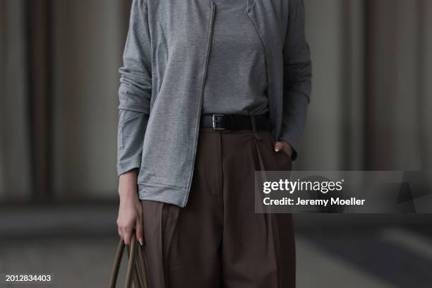 Maria Barteczko seen wearing HANRO light grey basic long sleeve, HANRO light grey basic zip jacket, Arket brown belted wide leg pants, THE ROW brown...