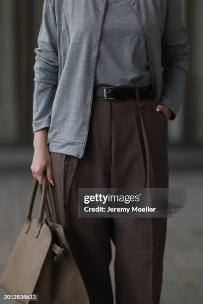 Maria Barteczko seen wearing HANRO light grey basic long sleeve, HANRO light grey basic zip jacket, Arket brown belted wide leg pants, THE ROW brown...