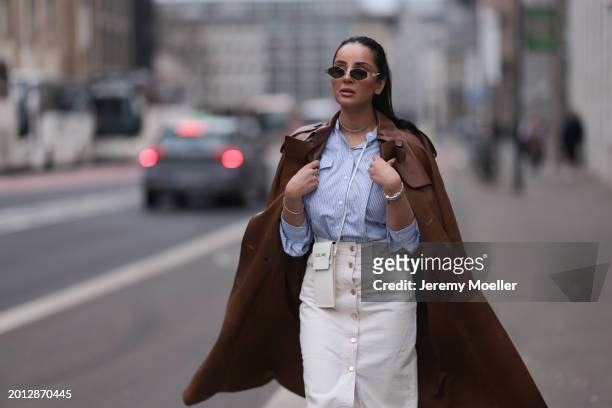 Tara Tut seen wearing Celine gold Triomphe sunglasses, gold earrings, & Other Stories blue / white striped buttoned blouse shirt, Zara white denim /...