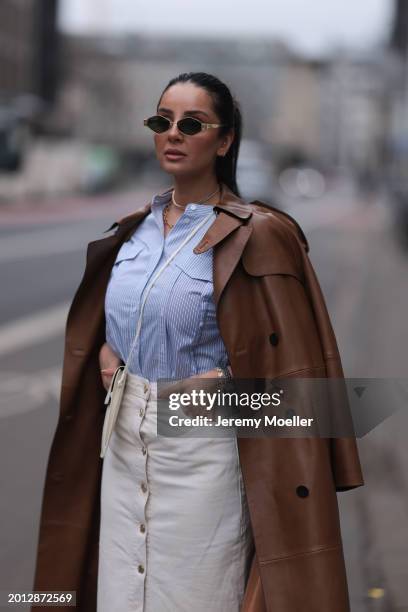 Tara Tut seen wearing Celine gold Triomphe sunglasses, gold earrings, & Other Stories blue / white striped buttoned blouse shirt, Zara white denim /...