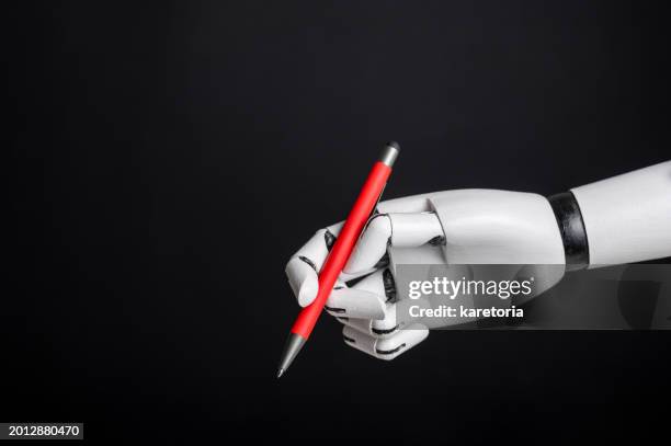 robotic hand holding pen - handschrift stock-fotos und bilder