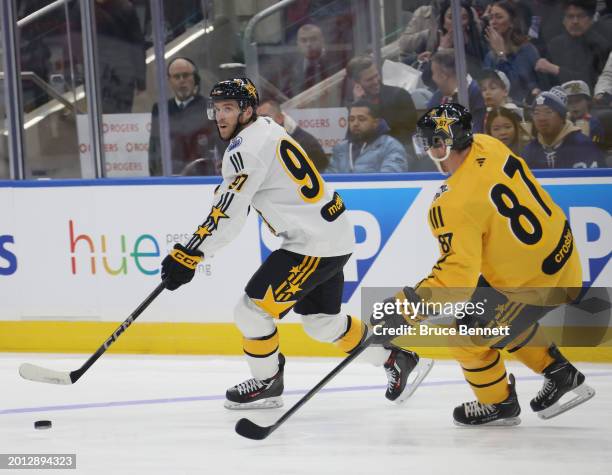 Connor McDavid of the Edmonton Oilers skates against Sidney Crosby of the Pittsburgh Penguins during the 2024 NHL All-Star Game on February 03, 2024...