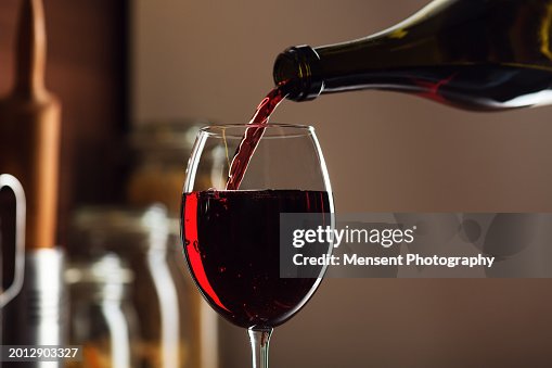 Red wine being poured in a glass Red wine being poured in a glass