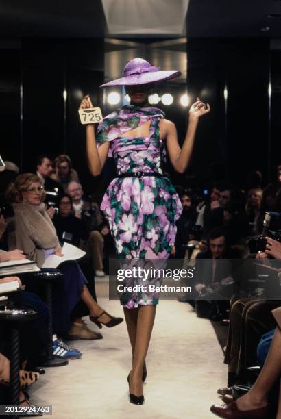 Model wearing a floral print dress and wide-brimmed hat from Chanel's collection for spring and summer, Paris, January 30th 1979.