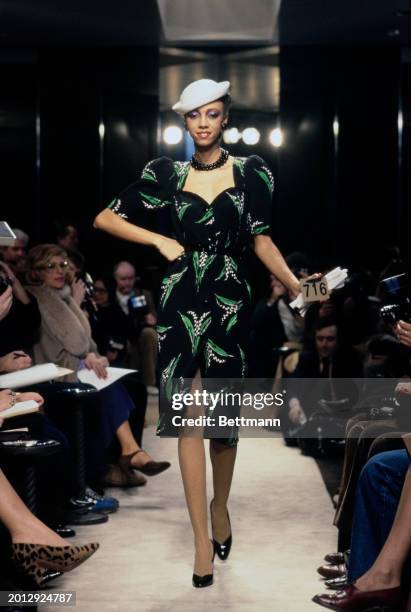 Model wearing a black dress with floral print from Chanel's collection for spring and summer, Paris, January 30th 1979.