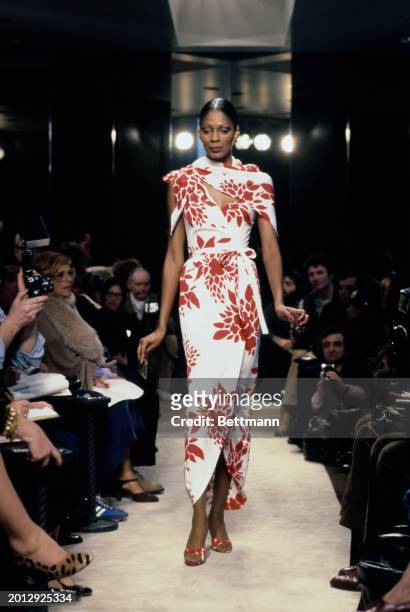 Model wearing a red and white floral print wrap dress from Chanel's collection for spring and summer, Paris, January 30th 1979.