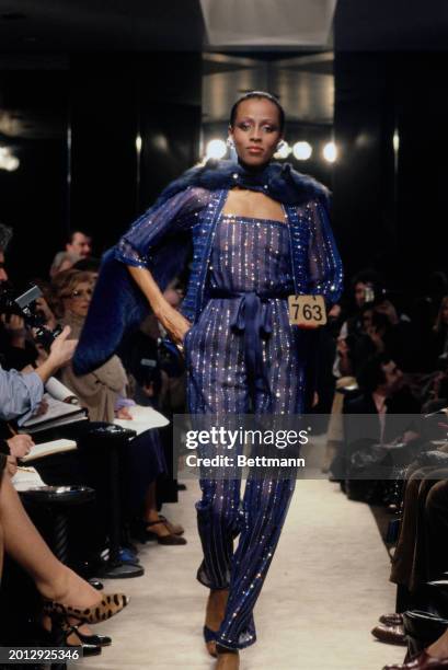 Model wearing a translucent jumpsuit with sequins and matching jacket from Chanel's collection for spring and summer, Paris, January 30th 1979.