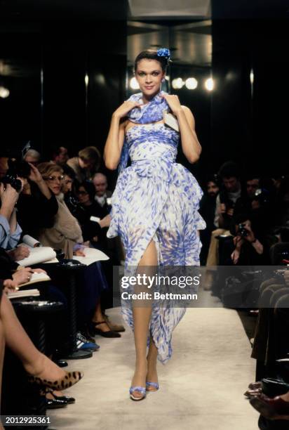 Model wearing a sleeveless dress with matching shawl and fascinator from Chanel's collection for spring and summer, Paris, January 30th 1979.