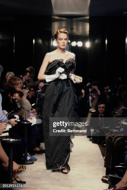 Model wearing a sleeveless black polka dot dress from Chanel's collection for spring and summer, Paris, January 30th 1979.