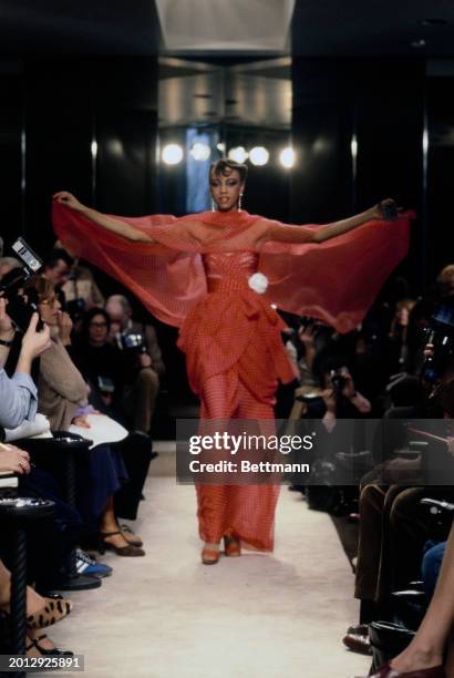 Model wearing red polka-dot dress with matching shawl and sandals from Chanel's collection for spring and summer, Paris, January 30th 1979.