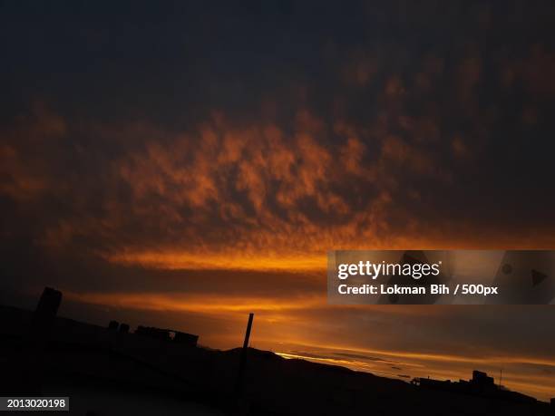 low angle view of silhouette of buildings against sky during sunset,morocco - 2013020198 stock pictures, royalty-free photos & images