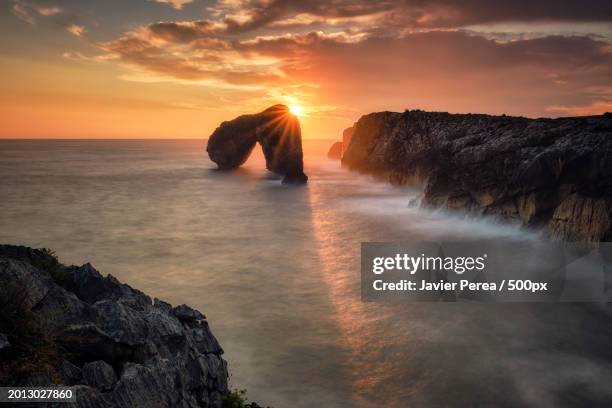 scenic view of sea against sky during sunset,llanes,asturias,spain - llanes stock-fotos und bilder