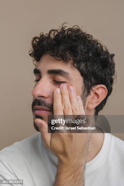 skin care concept. closeup of man with beard using face cream. - fashion suit stock pictures, royalty-free photos & images