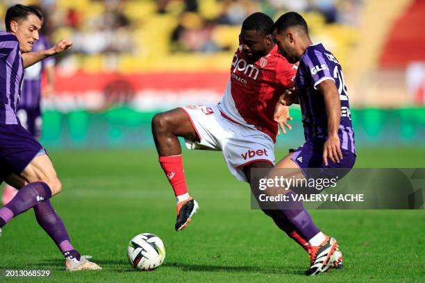 Monaco's French midfielder Youssouf Fofana fights for the ball with Toulouse's Swiss midfielder Vincent Sierro and Toulouse's Venezuelan midfielder...