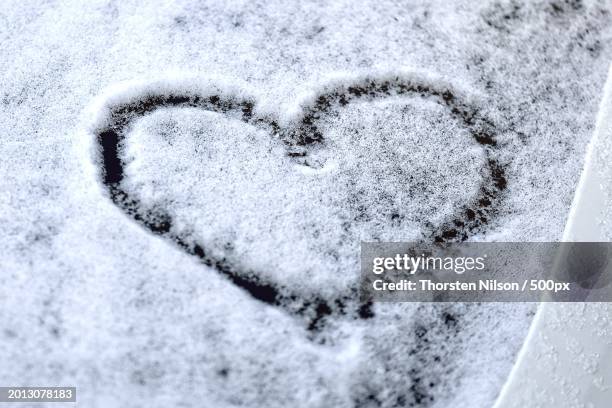 close-up of heart shape on snow,germany - thorsten nilson stockfoto's en -beelden