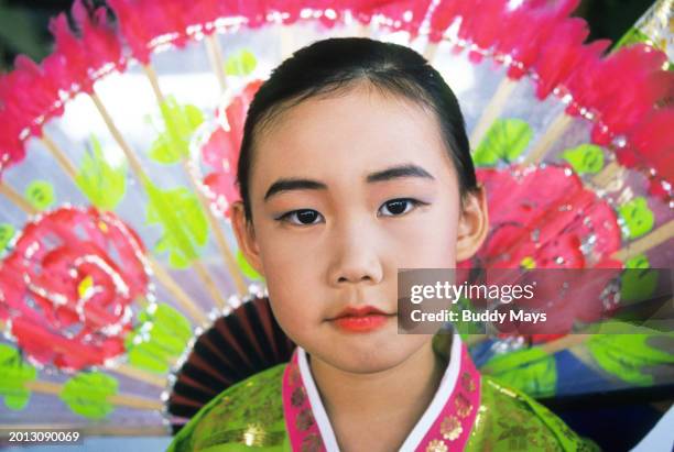 Five-year-old Asian girl dressed in traditional silk clothing, Vancouver, Canada, 2000. .