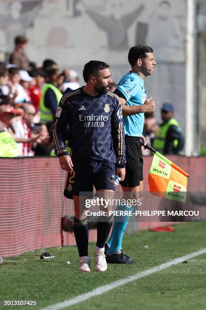 Real Madrid's Spanish defender Dani Carvajal leaves the pitch after receiving a red card during the Spanish league football match Rayo Vallecano de...