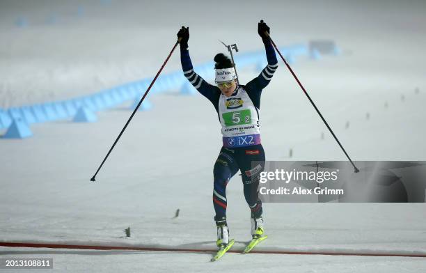 First placed Lou Jeanmonnot of France celebrates as she crosses the finish line during the Single Mixed Relay at the IBU World Championships Biathlon...