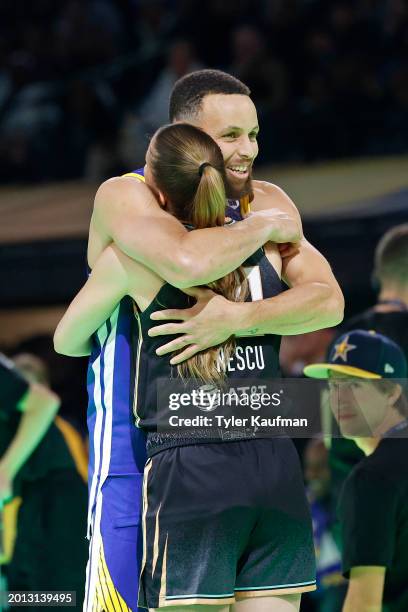 Sabrina Ionescu of the New York Liberty and Stephen Curry of the Golden State Warriors embrace during the State Farm All-Star Saturday Night on...