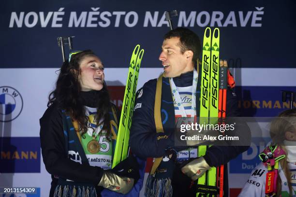 First placed Lou Jeanmonnot and Quentin Fillon Maillet of France celebrate on the podium following the Single Mixed Relay at the IBU World...