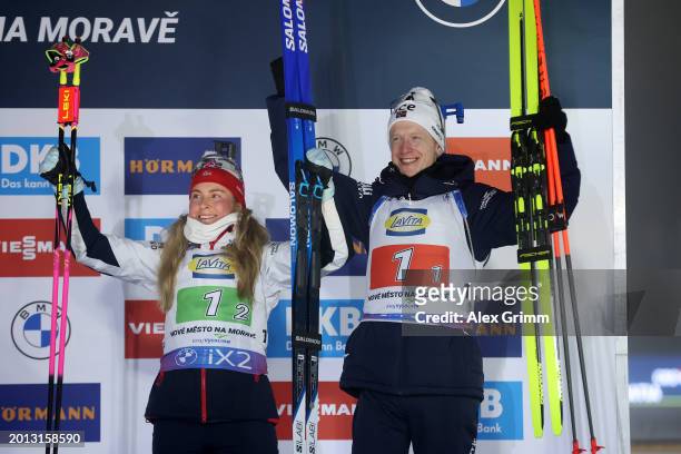 Third placed Johannes Thingnes Boe and Ingrid Landmark Tandrevold of Norway celebrate on the podium following the Single Mixed Relay at the IBU World...