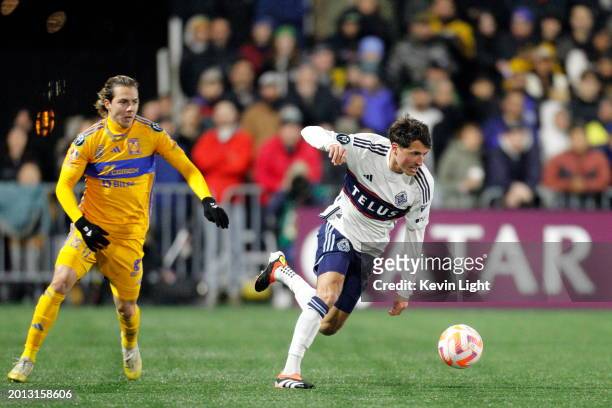 Alessandro Schopf of the Vancouver Whitecaps battles for the ball with Sebastian Cordova of Tigres UANL during leg one of the Concacaf Champions...