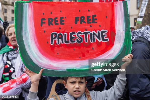 Young pro-Palestinian protester holds a sign in the form of a watermelon during a Global Day of Action to call for an immediate and permanent...