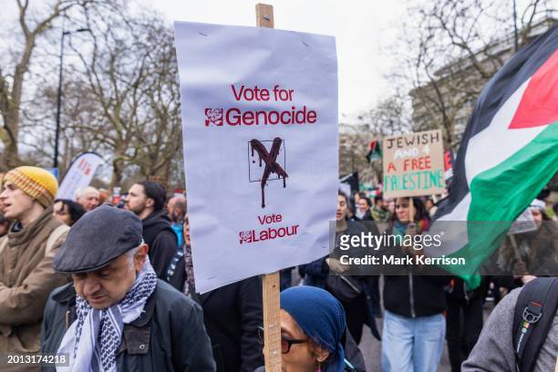 Pro-Palestinian protester holds a sign criticising the Labour Party's stance during a Global Day of Action to call for an immediate and permanent...