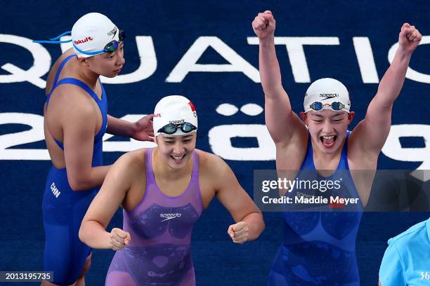 Yanhan Ai, Zhenqi Gong and Bingjie Li of Team People's Republic of China react as teammate Peiqi Yang competes in the Women's 4x200m Freestyle Final...