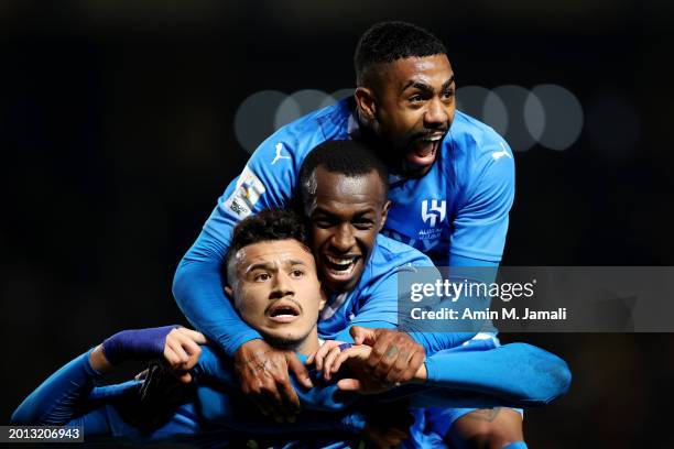 Abdullah Al-Hamddan of Al Hilal celebrates with teammates Saud Abdulhamid and Malcom after scoring his team's third goal during the AFC Champions...