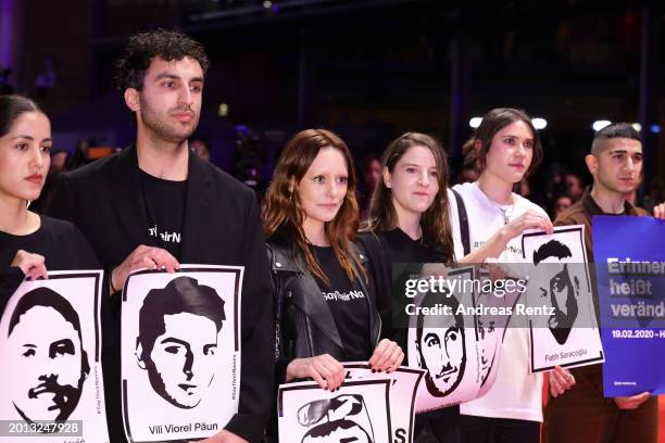 People join a protest remembering the victims of the Hanau attack at the "Small Things Like These" premiere and Opening Red Carpet for the 74th...