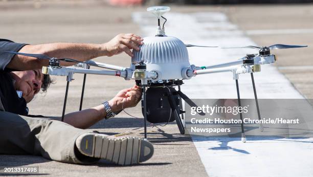 David Dunaway, of Intuitive Machines, attaches the tether line to a drone during a tethered drone system demonstration at the new Houston Spaceport...
