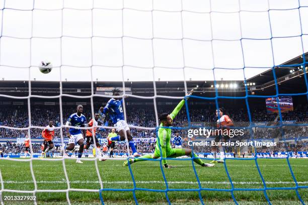 Aiyegun Tosin of Lorient attempts a kick while being defended by Goalkeeper Alaa Bellaarouch of Strasbourg during the Ligue 1 Uber Eats match between...