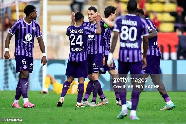 Toulouse's Swiss midfielder Vincent Sierro and other Toulouse players react after winning the French L1 football match between AS Monaco and Toulouse...