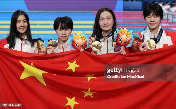 Gold Medalists, Yanhan Ai, Zhenqi Gong, Bingjie Li and Peiqi Yang of Team People's Republic of China pose with their medals and their country's flag...