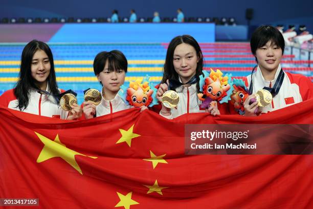 Gold Medalists, Yanhan Ai, Zhenqi Gong, Bingjie Li and Peiqi Yang of Team People's Republic of China pose with their medals and their country's flag...