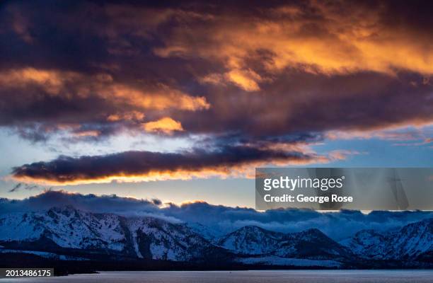 Clouds roll across the mountains on the California side of Lake Tahoe as viewed in this sunset photo taken from Harvey's Casino & Hotel on February 9...
