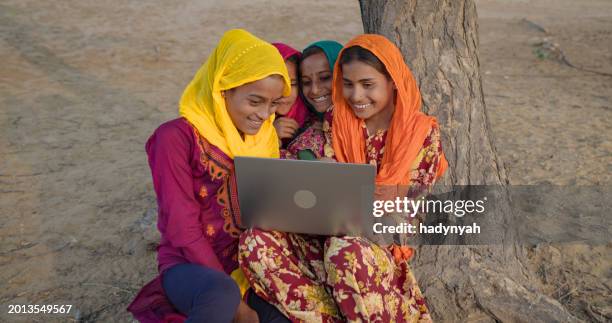 happy indian girls using laptop, india - laptop desert stock pictures, royalty-free photos & images