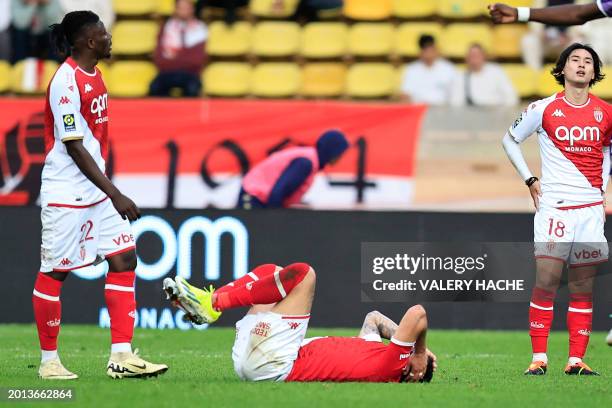 Monaco's Ghanaian defender Mohammed Salisu stands by Monaco's Chilean defender Guillermo Maripan as he grimaces after an injury next to Monaco's...