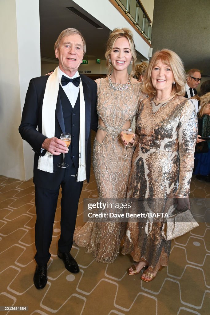 Emily Blunt poses with parents Oliver Blunt and Joanna Blunt at the
