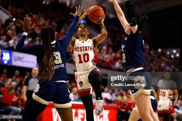 Aziaha James of the NC State Wolfpack puts up a shot against Kayla Blackshear of the Georgia Tech Yellow Jackets during the first half at Reynolds...