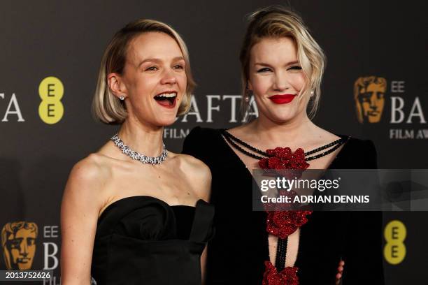 Emerald British actress and screenwriter Emerald Fennell and British actress Carey Mulligan pose on the red carpet upon arrival at the BAFTA British...