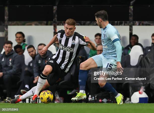 Newcastle United's Harvey Barnes slips as he evades a challenge from Bournemouth's Adam Smith during the Premier League match between Newcastle...