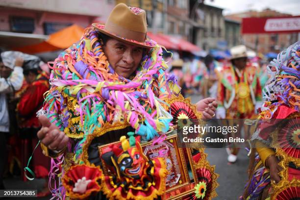 Man wearing traditional clothes and wrapped in serpentine dances during the iconic parade of 'Entierro del Pepino' at General Cemetery of La Paz on...