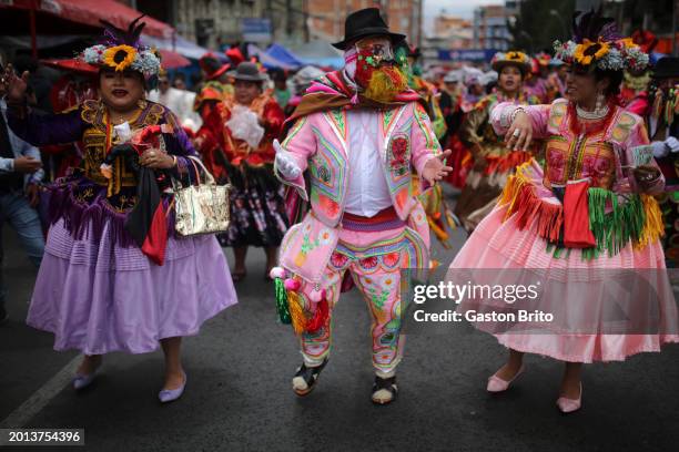 People wearing traditional clothes dance during the iconic parade of 'Entierro del Pepino' at General Cemetery of La Paz on February 18, 2024 in La...